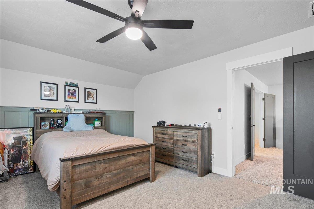 4150 East Fratello Street Meridian, ID 83642 - Photo 30 of 46 Bedroom featuring lofted ceiling, carpet flooring, ceiling fan, and a textured ceiling