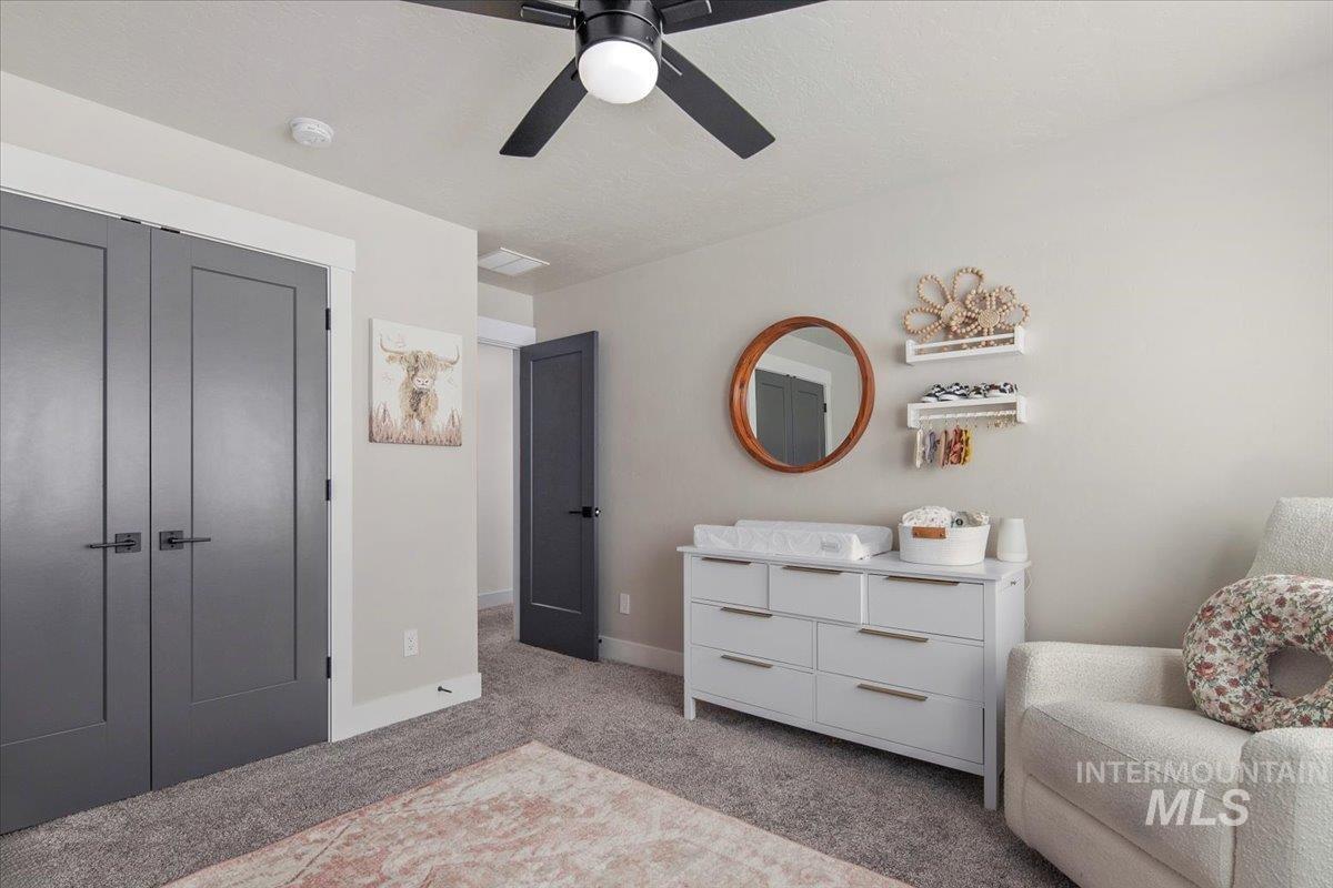 4150 East Fratello Street Meridian, ID 83642 - Photo 33 of 46 Bedroom with a closet, light colored carpet, and ceiling fan