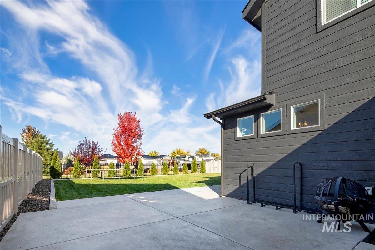 4150 East Fratello Street Meridian, ID 83642 - Photo 40 of 47 Fenced backyard featuring a patio, a residential view, and an outdoor fire pit
