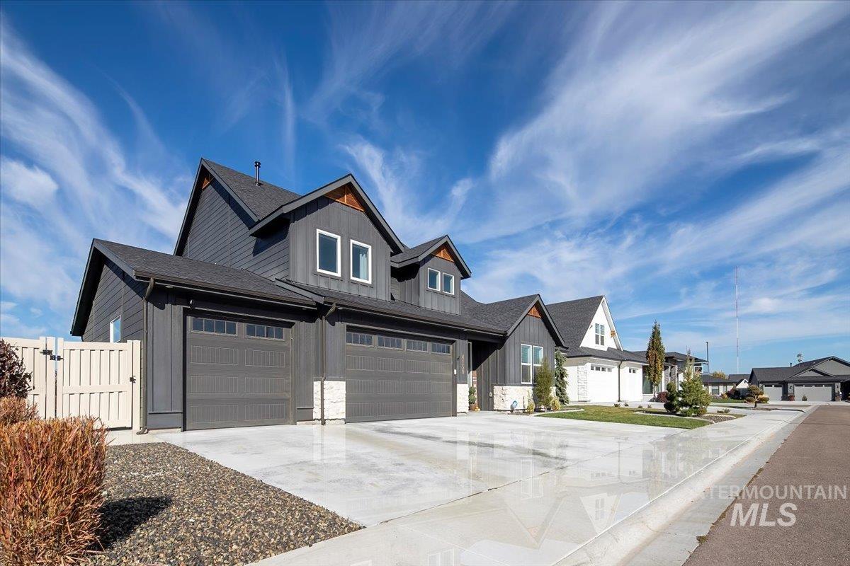 4150 East Fratello Street Meridian, ID 83642 - Photo 45 of 47 View of front facade featuring driveway, board and batten siding, a gate, a residential view, and roof with shingles