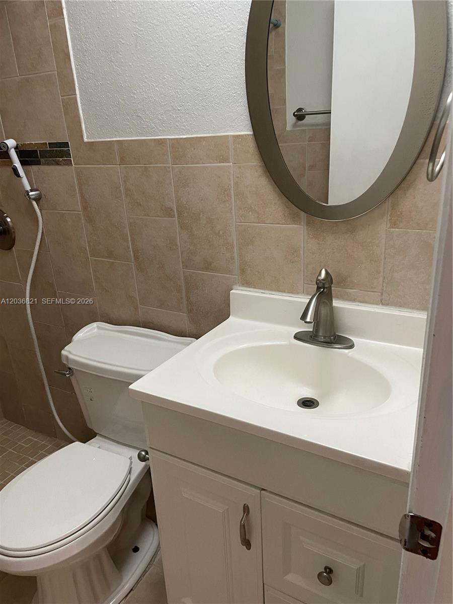 14770 Southwest 60th Street Miami, FL 33193 - Photo 15 of 16 a bathroom with a sink a toilet and a mirror