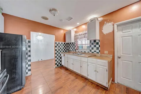 a bathroom with a double vanity sink toilet and shower