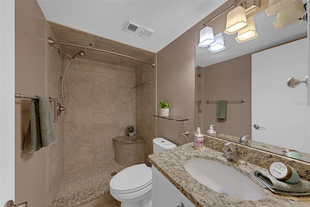 Undisclosed Address Astor, FL 32102 - Photo 17 of 28 a bathroom with a granite countertop sink toilet a mirror and shower