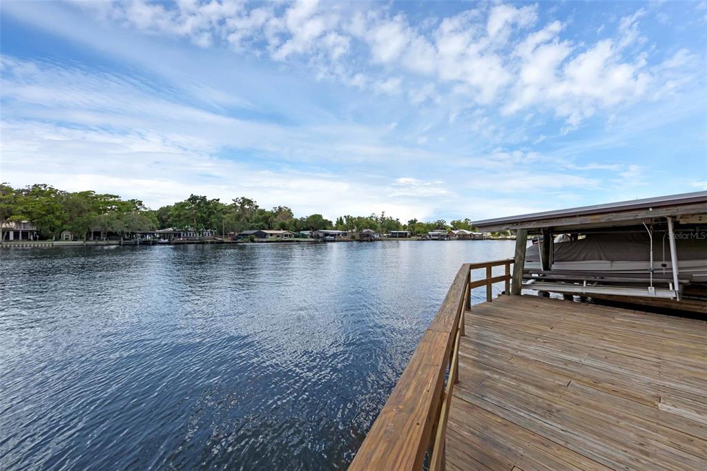 Undisclosed Address Astor, FL 32102 - Photo 26 of 28 a view of a lake with houses in the background