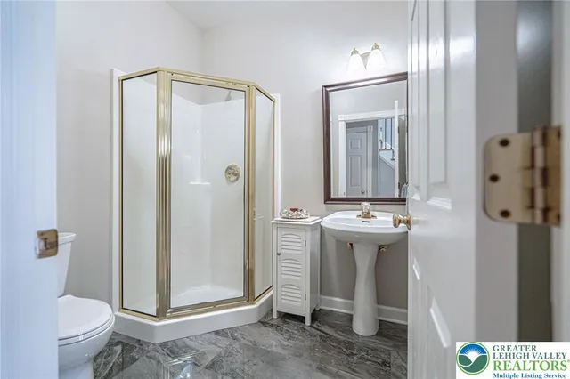 a view of a hallway with wooden floor and entryway