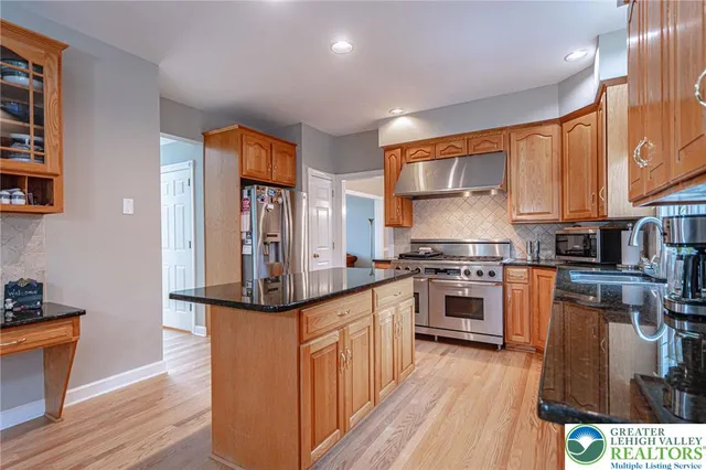 a spacious bedroom with a bed and a chandelier