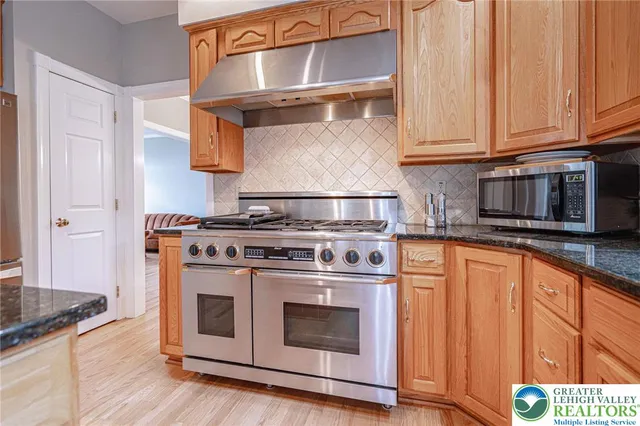 a view of walk in closet with clothes