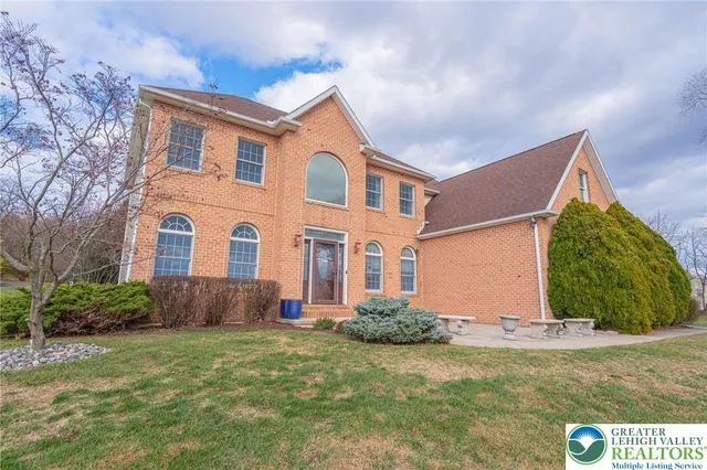 a kitchen with stainless steel appliances granite countertop a stove a sink dishwasher and a refrigerator with wooden floor