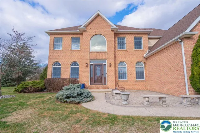 a kitchen with stainless steel appliances granite countertop a stove a sink dishwasher and a refrigerator with wooden floor