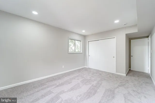 a view of an empty room with windows