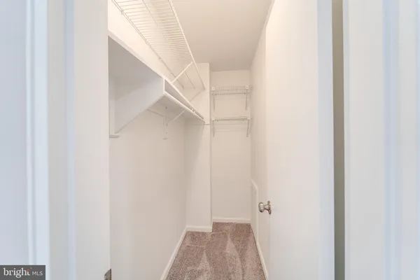 a view of a hallway with white walls