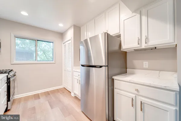 a kitchen with stainless steel appliances a refrigerator sink and cabinets