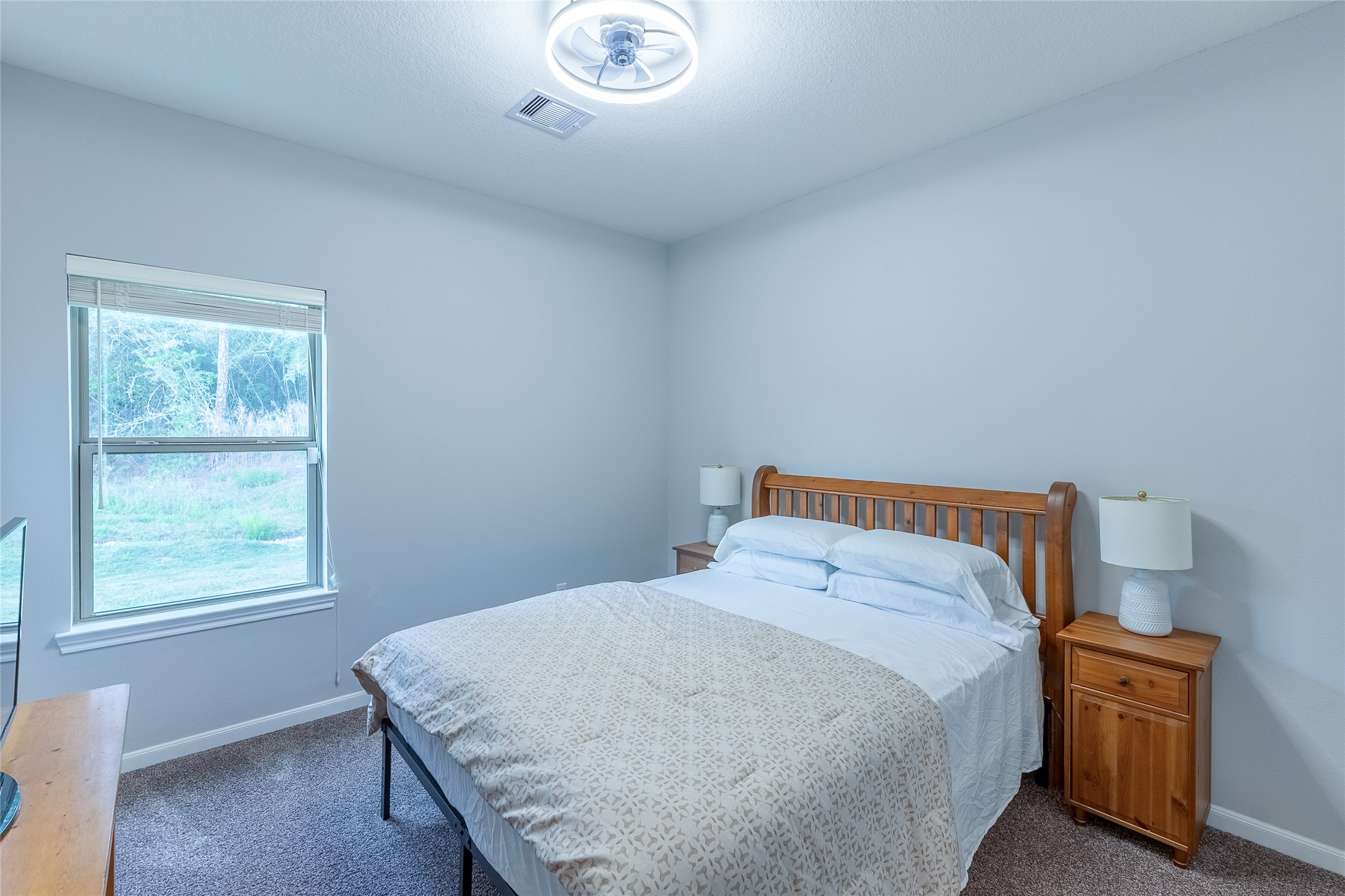 120 Sanctuary Road Huntsville, TX 77340 - Photo 17 of 38 a bedroom with a bed and wooden floor
