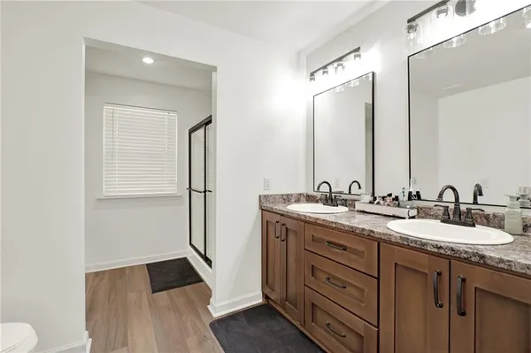 a bathroom with a double vanity sink and mirror