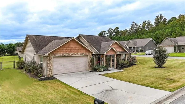 a view of a big house with wooden fence