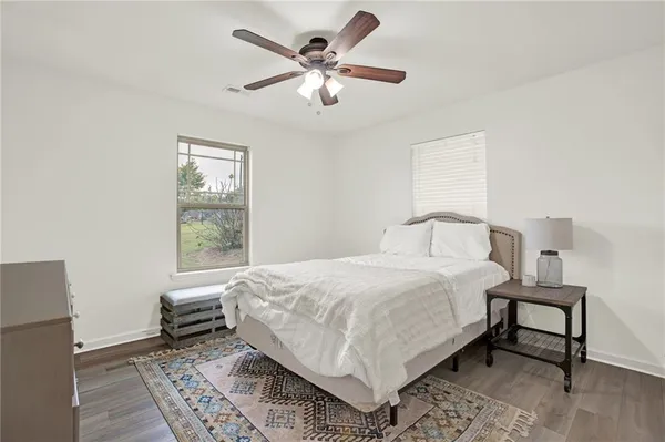 a bedroom with a bed and a chair