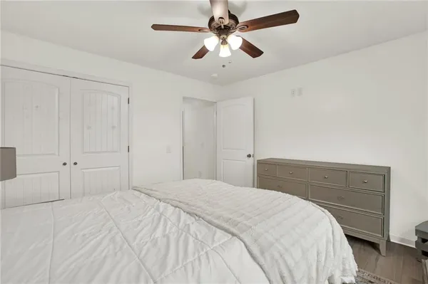 a bedroom with a bed and a ceiling fan