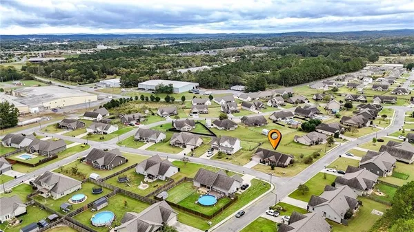 an aerial view of residential houses with outdoor space