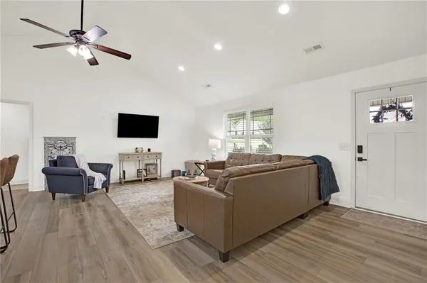 a living room with furniture and a flat screen tv
