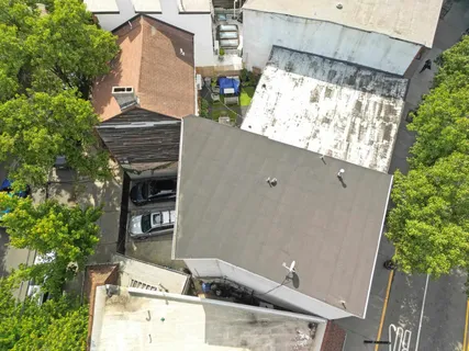 an aerial view of a house with a yard and parking