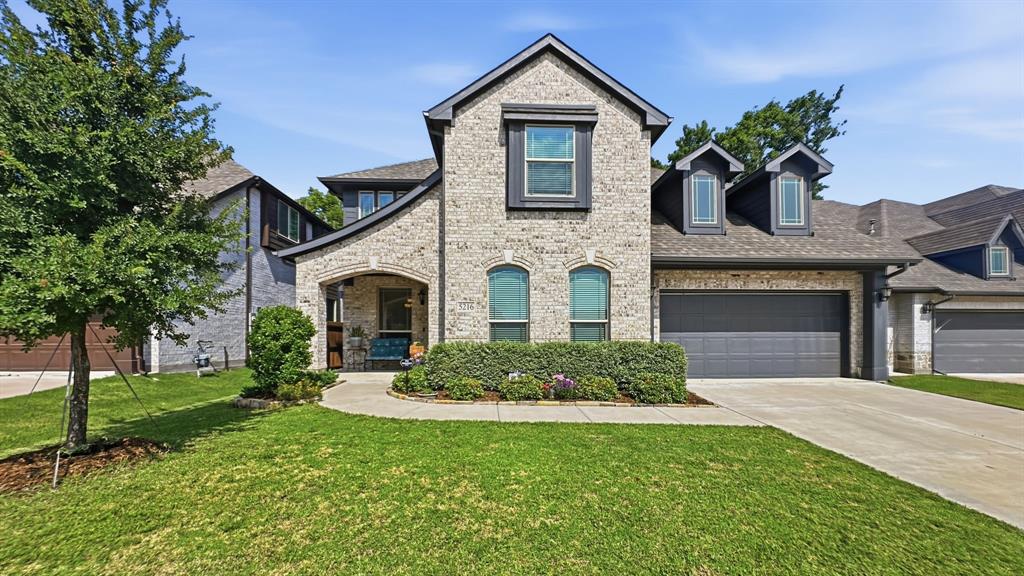 5216 Troupe Road McKinney, TX 75071 - Photo 1 of 40 Brick veneer exterior featuring dark gray trim and a multi-level roofline