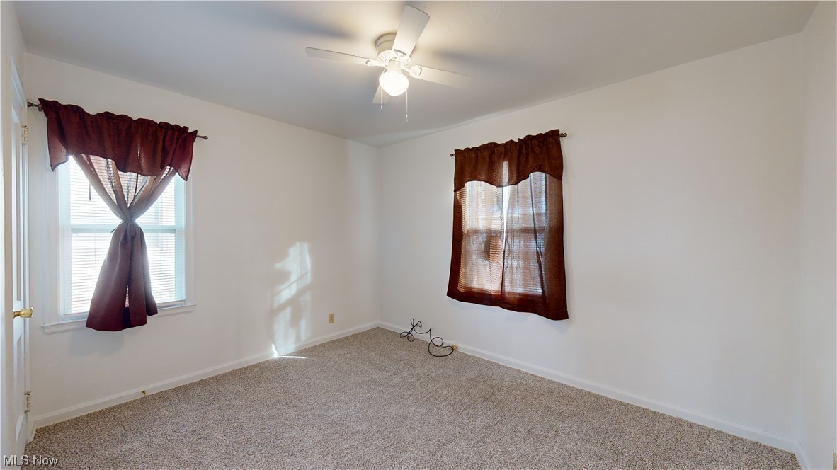 804 Kickapoo Avenue Akron, OH 44305 - Photo 9 of 24 Master bedroom with brand new 2023: paint, carpet, ceiling fan, blinds, and window treatments.