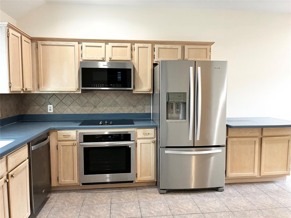 7936 Tournament Road Frisco, TX 75035 - Photo 9 of 28 a kitchen with a refrigerator sink and microwave