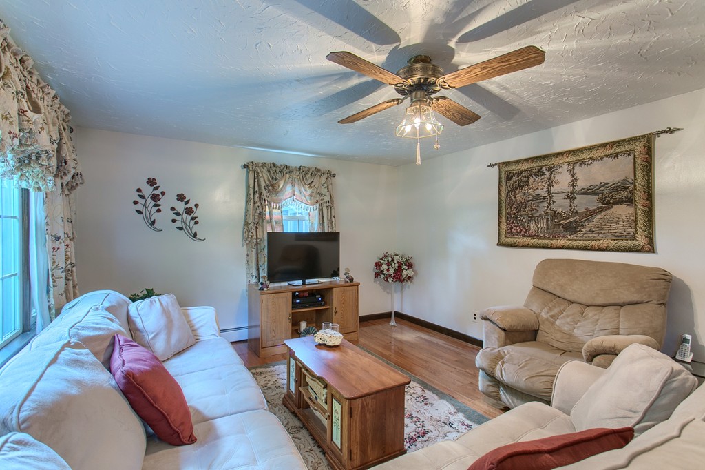 567 Richardson Road Ashby, MA 01431 - Photo 19 of 26 a living room with furniture and a flat screen tv