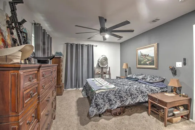 a bedroom with a bed and a dresser