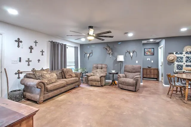 a living room with furniture and a chandelier
