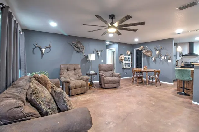 a living room with furniture and a large window