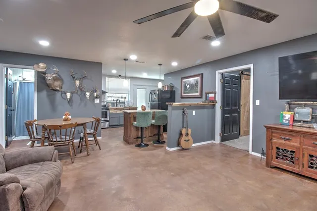a view of a livingroom with furniture and a flat screen tv