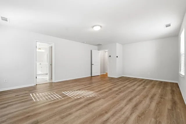 a view of an empty room and wooden floor