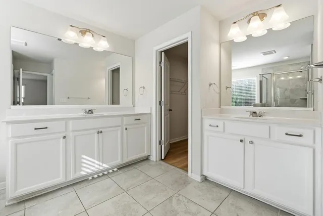 a bathroom with a double vanity sink and a mirror