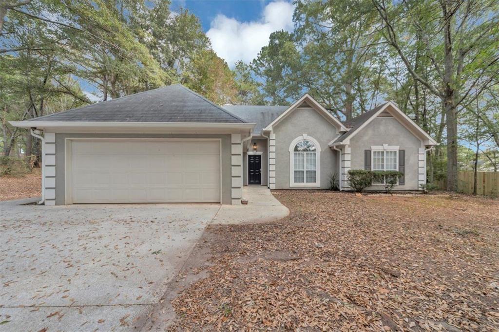 40 Magnolia Walk Covington, GA 30016 - Photo 1 of 1 a front view of a house with a yard and garage