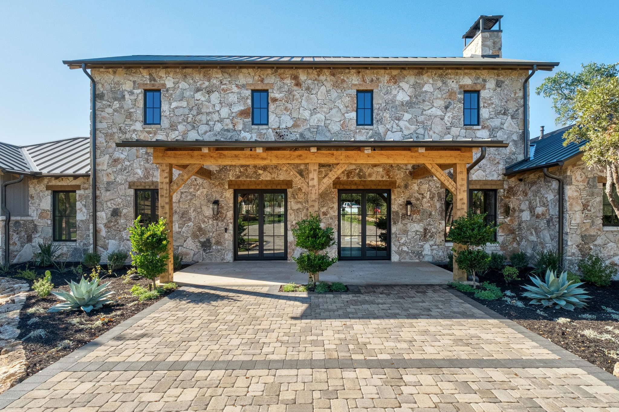 0 Old Red Ranch Road Dripping Springs, TX 78620 - Photo 3 of 40 a front view of a house with garden