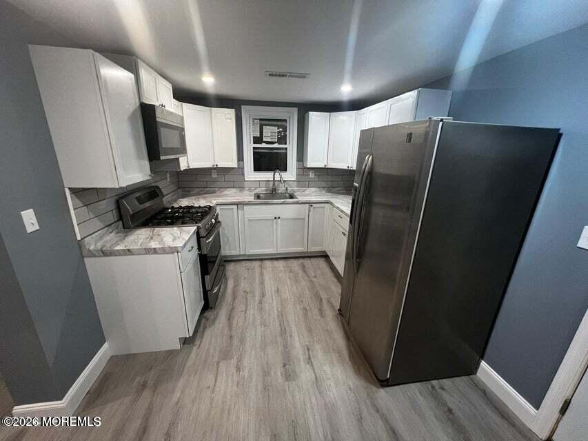 6611 Magnolia Drive Millville, NJ 08332 - Photo 5 of 14 a kitchen with a refrigerator a sink and wooden floor