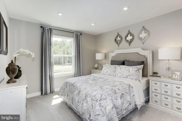 a bedroom with a large bed and a window