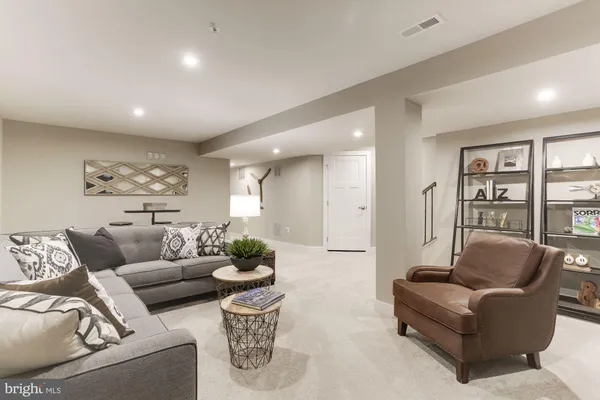 a living room with furniture and a potted plant
