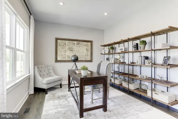 a living room with furniture stairs and a window