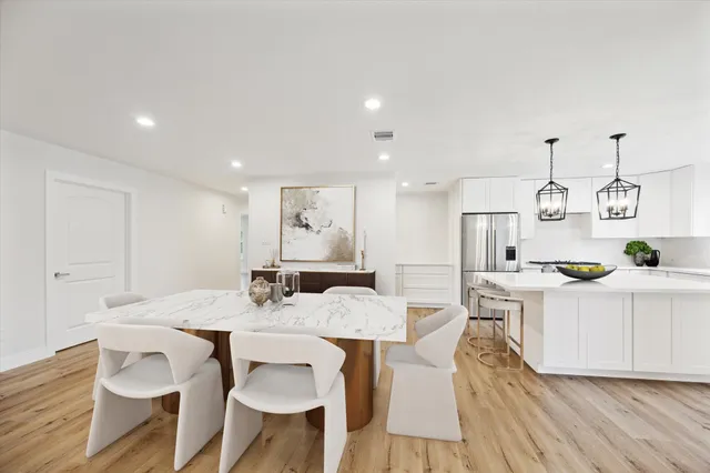 a view of kitchen with cabinets table and chairs