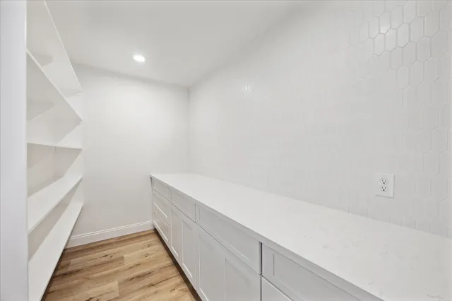 a view of a room with wooden floor and windows