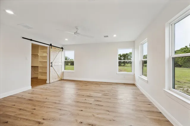 a view of hallway with wooden floor and staircase