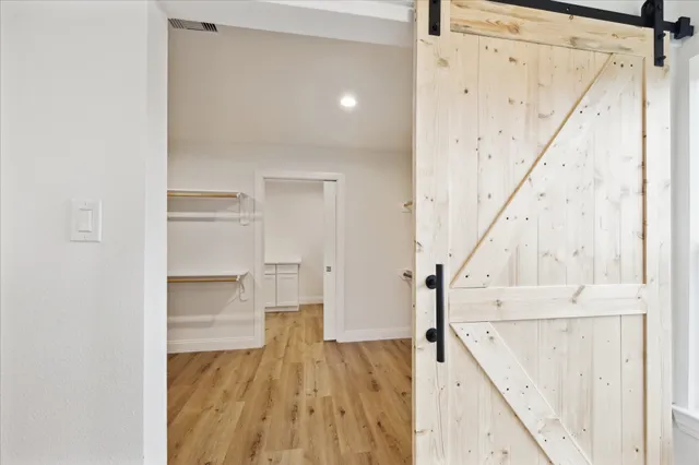 a view of walk in closet with empty racks