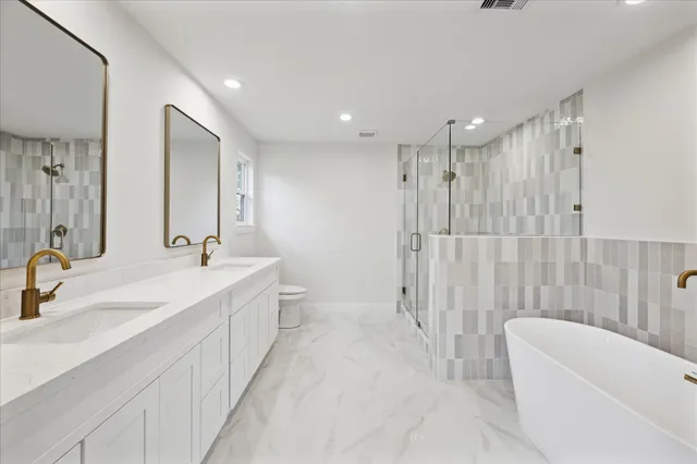 a bathroom with a double vanity sink mirror and double