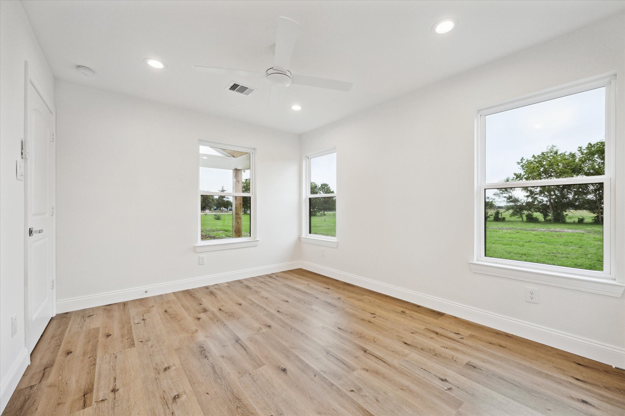 1935 Willow Road Wallis, TX 77485 - Photo 26 of 34 an empty room with wooden floor and windows