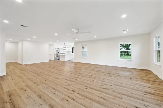 a view of kitchen and a window with wooden floor