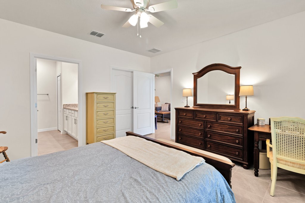 6035 Red Maple Manor Vero Beach, FL 32966 - Photo 15 of 36 a bedroom with a bed and a dresser