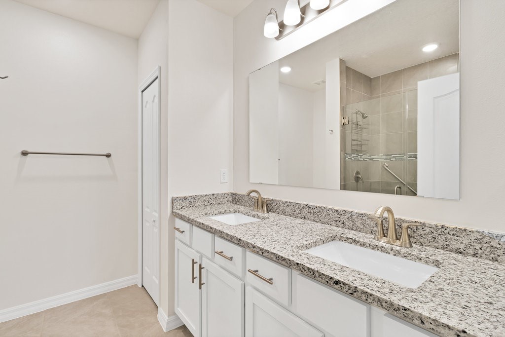 6035 Red Maple Manor Vero Beach, FL 32966 - Photo 16 of 36 a bathroom with a granite countertop sink and a mirror
