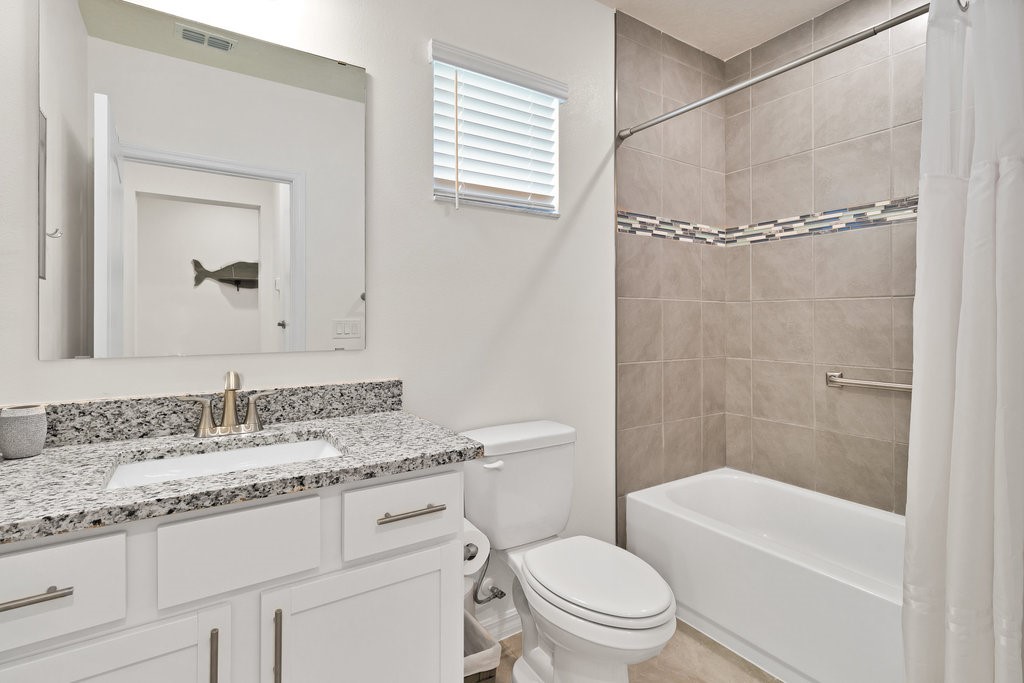 6035 Red Maple Manor Vero Beach, FL 32966 - Photo 20 of 36 a bathroom with a granite countertop sink toilet and shower